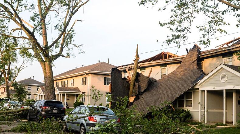 What remains of a roof dangles in front of a home after being taken off by a tornado that damaged approximately 150 homes May 27 in the Properties of Wright-Field at Wright-Patterson Air Force Base. Volunteers from around Wright-Patterson AFB worked alongside base emergency responders and housing residents to ensure everyone’s safety and begin the cleanup process. (U.S. Air Force photo/Wesley Farnsworth)