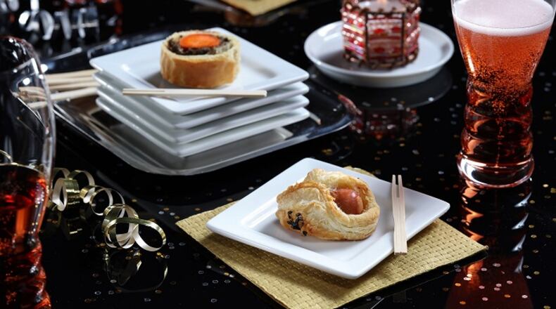Sausage turnovers (aka pigs in blanket), foreground, are a step up from the usual when wrapped in puffed pastry, on Tuesday Dec., 12, 2017. (Abel Uribe/Chicago Tribune/TNS)