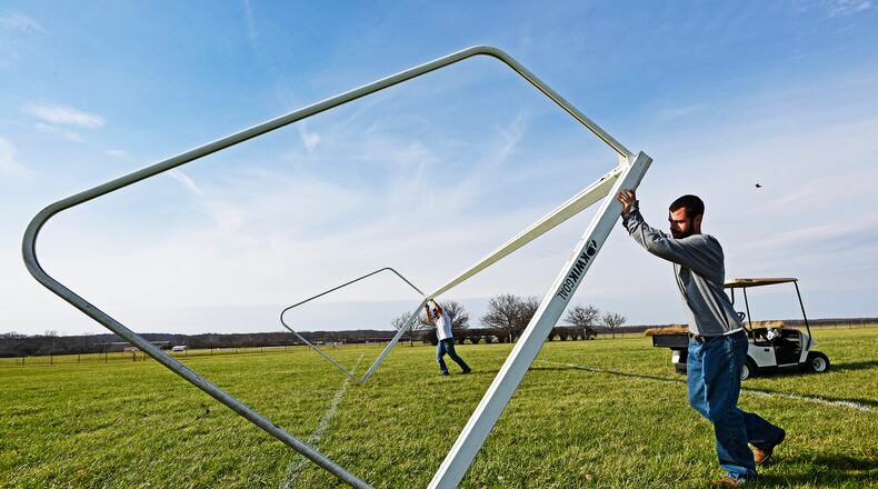 Miamisburg Soccer Association members put a goal in place on a soccer field in Miamisburg. STAFF FILE