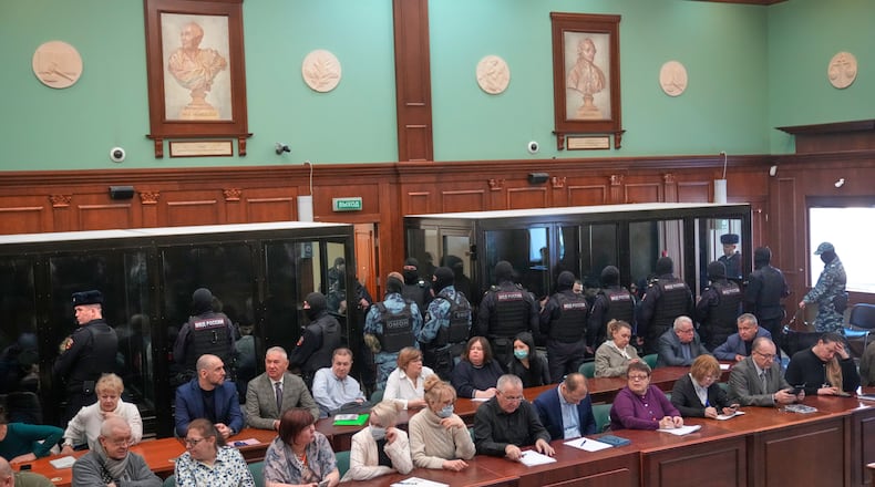 Men tried on the charges of involvement in a terror attack at the Crocus City Hall in March 2024 listen to the verdict in a glass cage at the Second Western District Military Court in Moscow, Russia, Thursday, March 12, 2026. (AP Photo/Pavel Bednyakov)