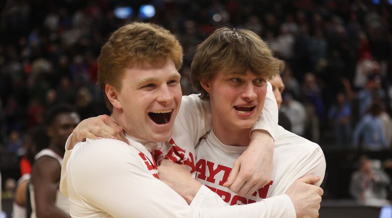 Dayton's Will Maxwell and Atticus Schuler celebrate a victory against Nevada in the first round of the NCAA tournament on Thursday, March 21, 2024, at the Delta Center in Salt Lake City, Utah. David Jablonski/Staff