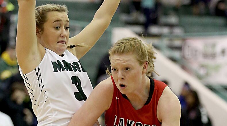 Lakota West guard/forward Abby Prohaska drives past Mason’s Saylor Norton during their Jan. 28 game at Mason. CONTRIBUTED PHOTO BY E.L. HUBBARD