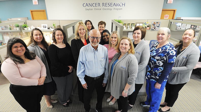 The staff of the Dayton Clinical Oncology Program, from left, Biza Munoz-Brito, Anna Kemper, Andrea Sutphin, Mary Ontko, Karen Dickerson, Dr. Howard Gross, Anna Pruett, Tiffany Jones, Lindsey Steve, Michelle Kinney, Amanda Kincaid, Myrna Hudak, Katie De Jesus. MARSHALL GORBY\STAFF