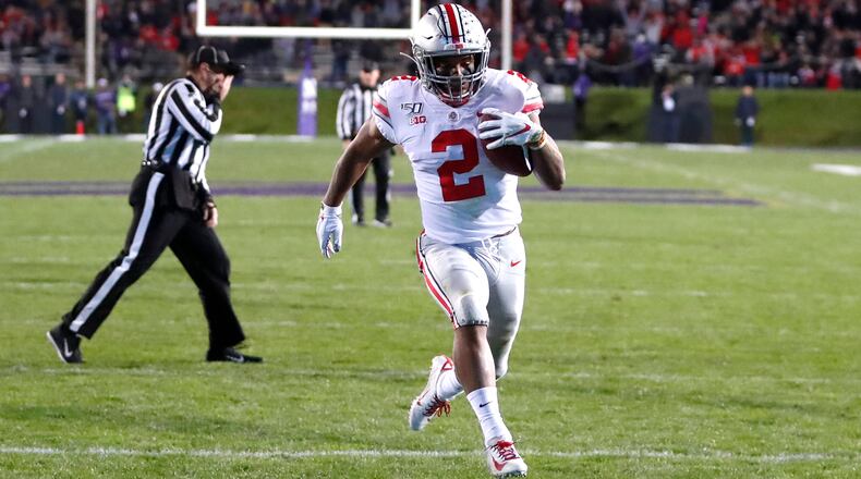Ohio State running back J.K. Dobbins scores on a pass from quarterback Justin Fields during the first half of an NCAA college football game against Northwestern, Friday, Oct. 18, 2019, in Evanston, Ill. (AP Photo/Charles Rex Arbogast)