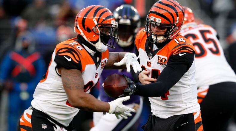 BALTIMORE, MD - DECEMBER 31: Quarterback Andy Dalton #14 hands the ball off to running back Joe Mixon #28 of the Cincinnati Bengals in the first quarter against the Baltimore Ravens at M&T Bank Stadium on December 31, 2017 in Baltimore, Maryland. (Photo by Todd Olszewski/Getty Images)