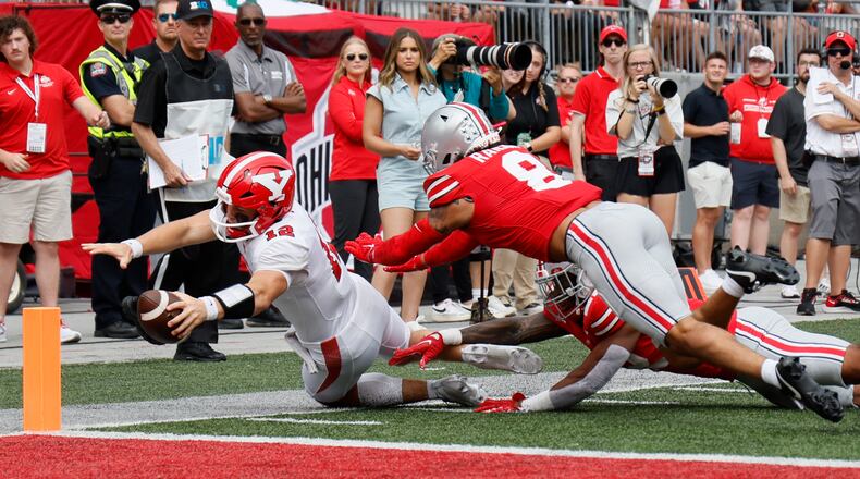 Youngstown State quarterback Beau Brungard, left, is forced out of bounds short of the goal line by Ohio State defensive back Lathan Ransom during the first half of an NCAA college football game Saturday, Sept. 9, 2023, in Columbus, Ohio. (AP Photo/Jay LaPrete)