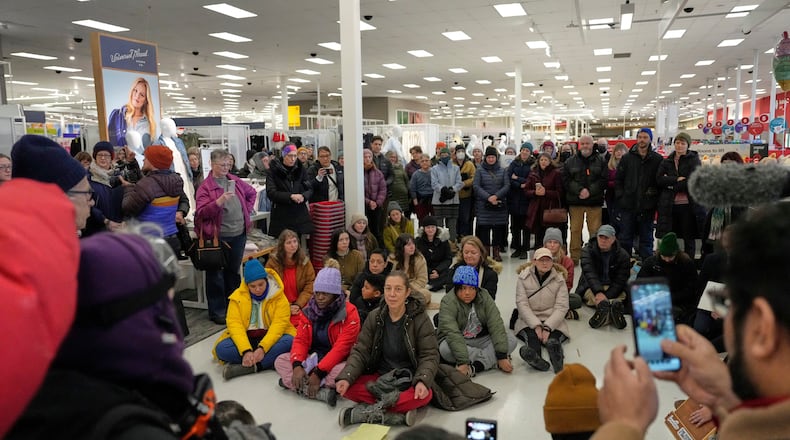 Community members and neighbors of people detained by ICE gather in protest at a Target store, Monday, Jan. 19, 2026, in St. Paul, Minn. (AP Photo/Yuki Iwamura)