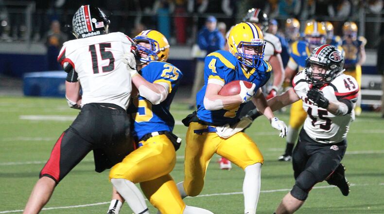 Peyton Otte of Marion Local (with ball) eludes Mark Seger (15) and Max Hoying (45) of Fort Loramie in previous action. Marion Local defeated New Bremen to claim the regional title on Saturday. MARC PENDLETON / STAFF
