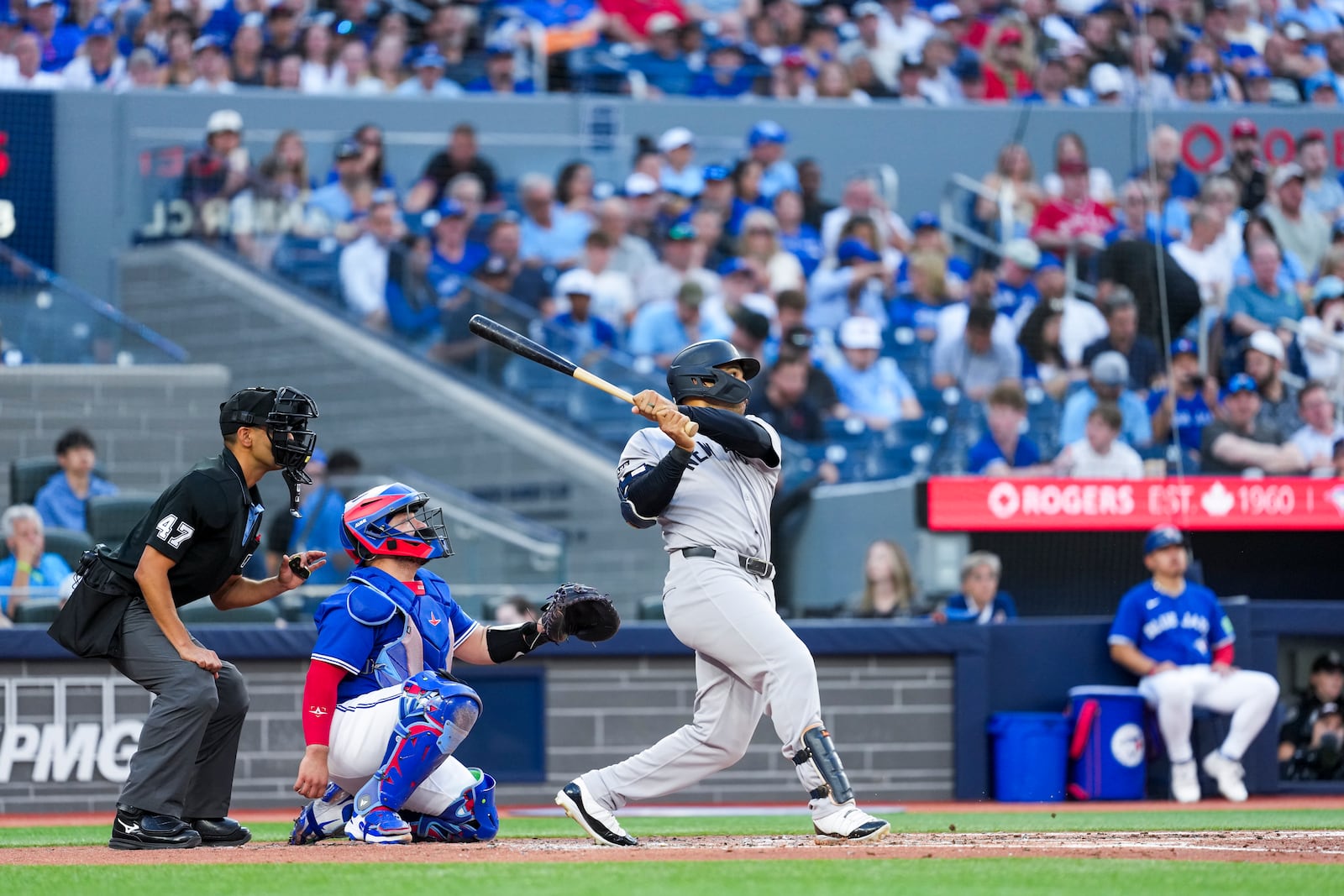New York Yankees' Trent Grisham (12) hits a solo home run against the Toronto Blue Jays during third inning MLB baseball action, in Toronto on Thursday, July 3, 2025. (Thomas Skrlj/The Canadian Press via AP)