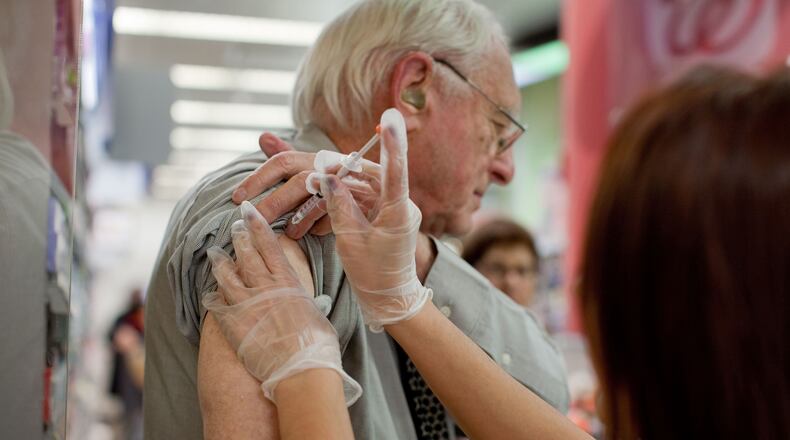 FILE — A man receives a flu shot at a pharmacy in Times Square in New York, Nov. 10, 2010. Influenza season goes until spring, so getting the vaccine late can still give you some protection, experts say. (Marcus Yam/The New York Times)