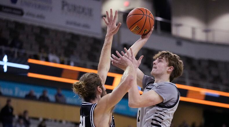 Northern Kentucky's Sam Vinson (2) shoots over Wright State's Tim Finke (24) during the first half of an NCAA college basketball game for the Horizon League men's tournament championship, Tuesday, March 8, 2022, in Indianapolis. (AP Photo/Darron Cummings)