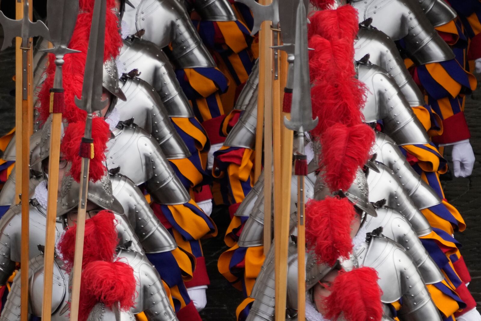 Pontifical Swiss guards arrive for the Easter mass in St. Peter's Square at the Vatican Sunday, April 20, 2025. (AP Photo/Gregorio Borgia)