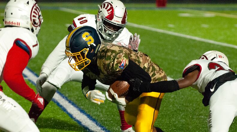 Springfield tailback Jeff Tolliver runs for yardage at Trotwood-Madison during the first half Friday, Nov. 1, at Springfield. Jeff Gilbert/CONTRIBUTED