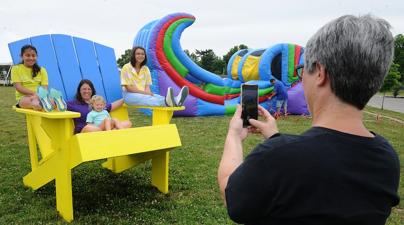 Cathy Ramirez, right, takes a photo Friday June 10, 2022 of, from left, Cecilia Ramirez, 9, Beth Conner, Charlie Stammer, 3, and Katie Conner, 13, at the city of West Carrollton's Sandmazing event located at 1 South Elm Street. MARSHALL GORBY\STAFF