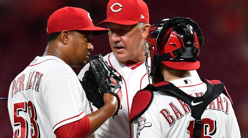 CINCINNATI, OH - JUNE 19: Pitching Coach Danny Darwin #52 of the Cincinnati Reds talks with pitcher Wandy Peralta #53 of the Cincinnati Reds and catcher Tucker Barnhart #16 of the Cincinnati Reds on the mound in the ninth inning against the Detroit Tigers at Great American Ball Park on June 19, 2018 in Cincinnati, Ohio. Cincinnati defeated Detroit 9-5. (Photo by Jamie Sabau/Getty Images)