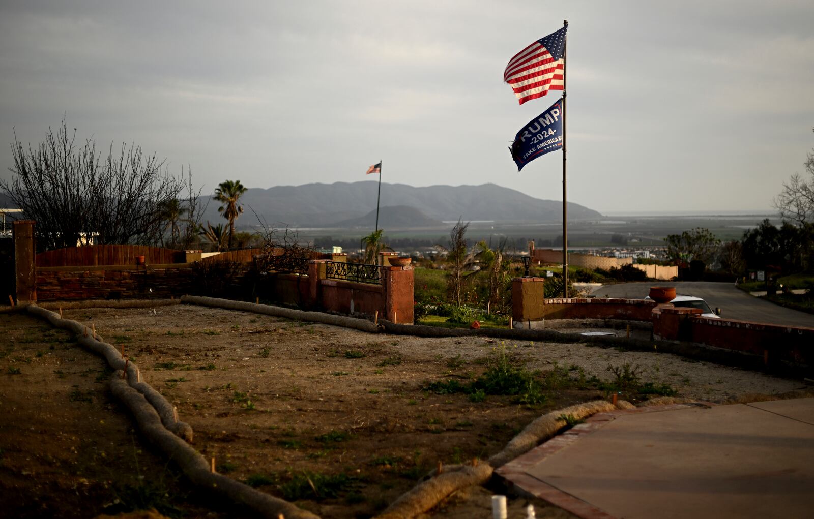 Flags fly along Esteban Drive after the Mountain Fire burned through the area Wednesday, April 16, 2025, in Camarillo, Calif. (AP Photo/Wally Skalij)