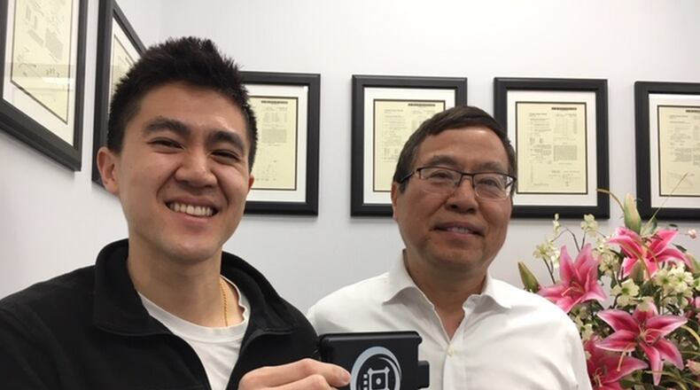 From left, Steven Hong, Oculii chief executive officer and co-founder, with Lang Hong, the company’s chief technology officer and co-founder, standing before a wall of patents that have been awarded to the Beavercreek software company. Steven Hong is holding the company’s “Falcon” radar unit. THOMAS GNAU/STAFF