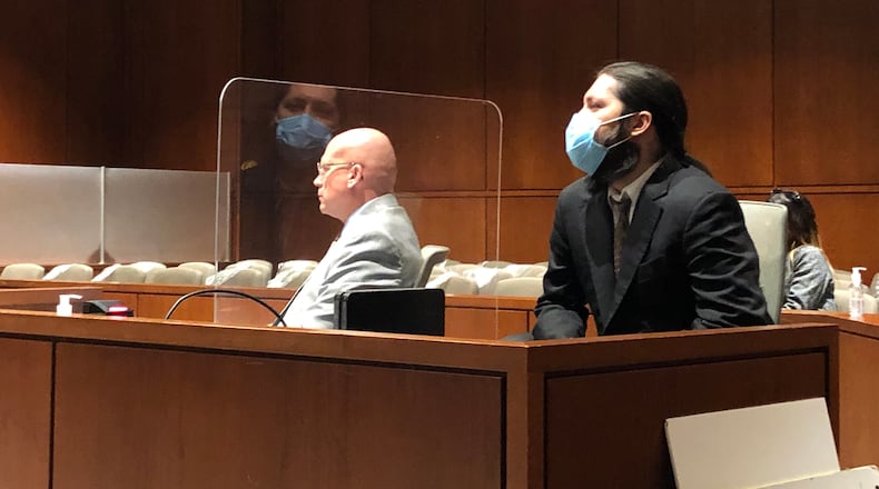 Brandon Dunham, at right listens with lawyer Jeff Meadows during final arguments in a trial in Warren County Common Pleas Court.