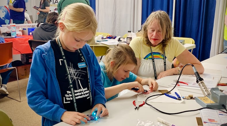 Two little girls from the Czech Republic construct FM radios at the 2025 Dayton Hamvention, Saturday May 17, 2025. LONDON BISHOP/STAFF