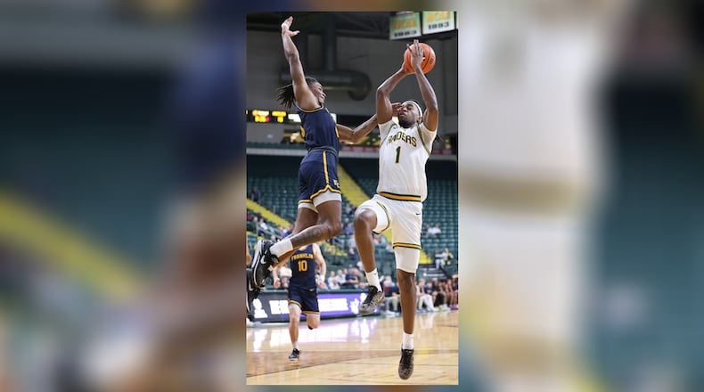 Wright State senior forward Bryan Etumnu shoots with pressure from Franklin College's LeBron Bennie-Powell during their season opener on Monday, Nov. 3 at Ervin J. Nutter Center. Etumnu scored seven points and had seven rebounds and four assists. BRYANT BILLING/STAFF