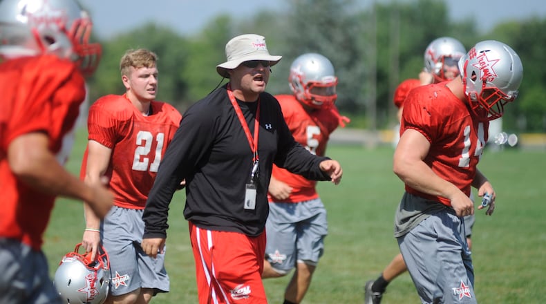 Matt Burgbacher (center) was Troy’s head football coach the last four seasons. MARC PENDLETON / STAFF