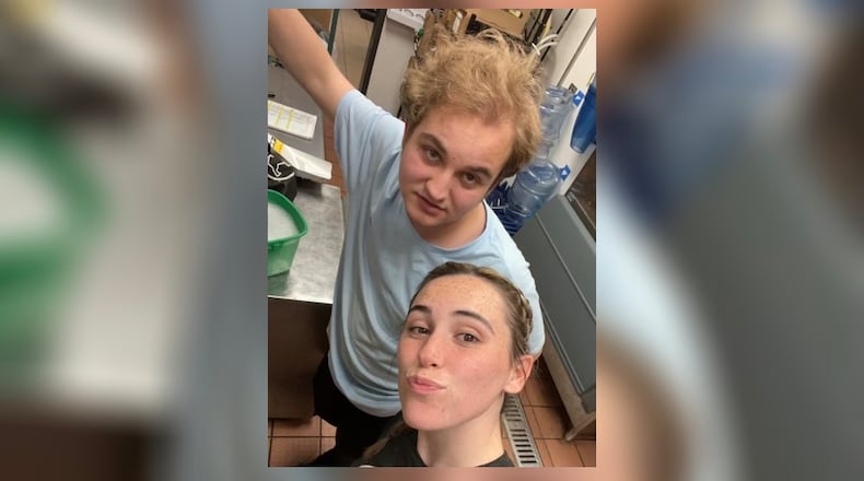 Isaiah Trammell and his friend, Caitlin Miner, take a photo together at their workplace in Lebanon. Photo courtesy Miner.