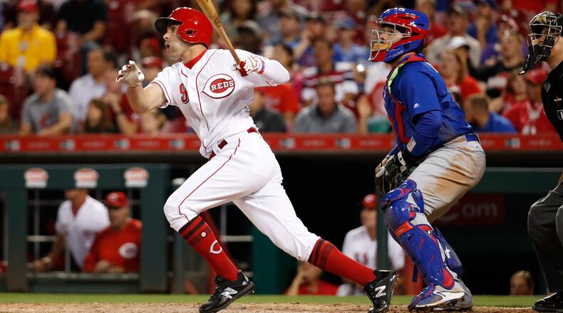 Cincinnati Reds’ Jose Peraza watches a two-run ground-rule double off Chicago Cubs relief pitcher Pedro Strop during the eighth inning of a baseball game, Thursday, Aug. 24, 2017, in Cincinnati. The Reds won 4-2. (AP Photo/John Minchillo)
