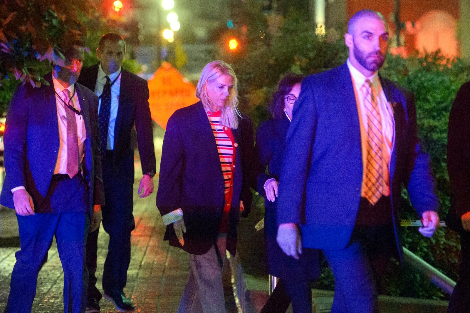 Attorney General Pam Bondi, center, walks to her car as law enforcement work the scene after two staff members of the Israeli Embassy in Washington were shot and killed outside the Capital Jewish Museum, Thursday, May 22, 2025, in Washington. (AP Photo/Rod Lamkey, Jr.)