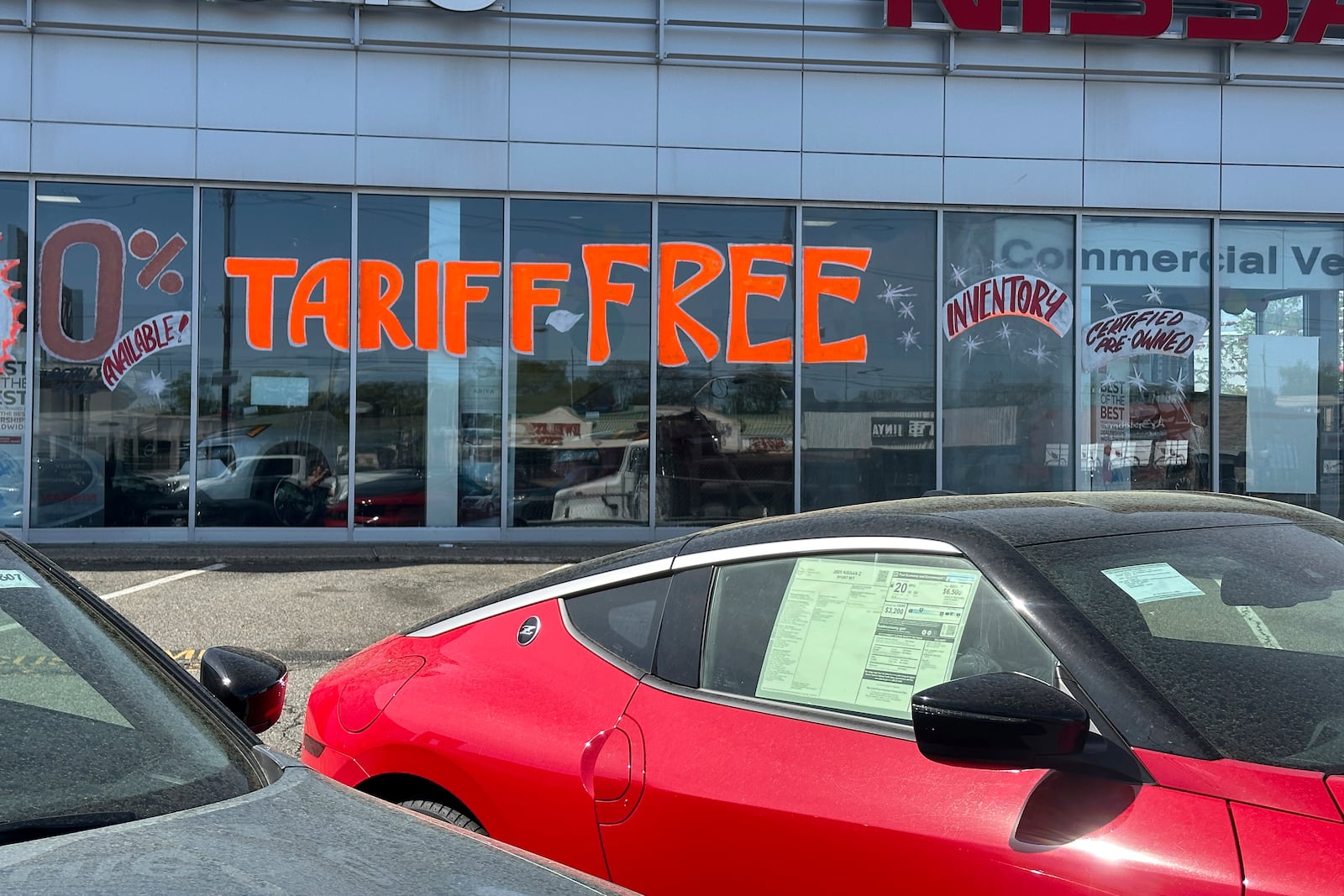 FILE - A Tariff Free sign to attract vehicle shoppers is at an automobile dealership in Totowa, N.J., on April 30, 2025. (AP Photo/Ted Shaffrey)