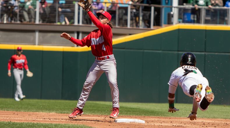 Dayton's Victor Acosta dives into second with a stolen base while Fort Wayne shortstop Nik McClaughry awaits the throw Saturday at Day Air Ballpark. Acosta came around to score on two wild pitches. Jeff Gilbert/CONTRIBUTED