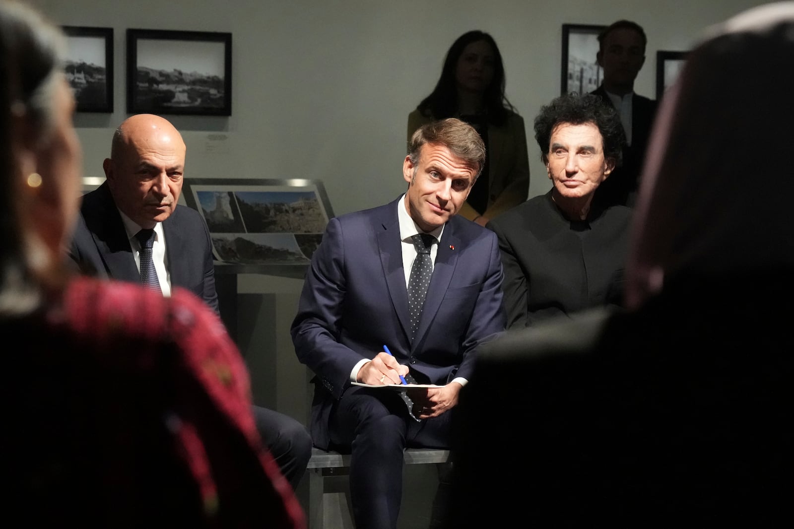 French President Emmanuel Macron, center, Hani al-Hayek, left, the Palestinian Authority's minister for heritage and tourism and IM director Jack Lang listen as they visit the exhibition "Treasures rescued from Gaza" Monday, April 14, 2025 at the Arab World Institute (IMA) in Paris. (AP Photo/Michel Euler, Pool)