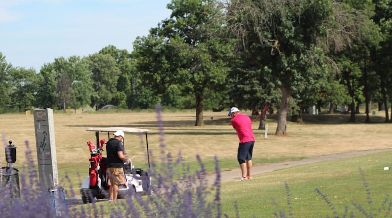 Players are shown at Kittyhawk Golf Center, part of Dayton’s golf system. CORNELIUS FROLIK / STAFF
