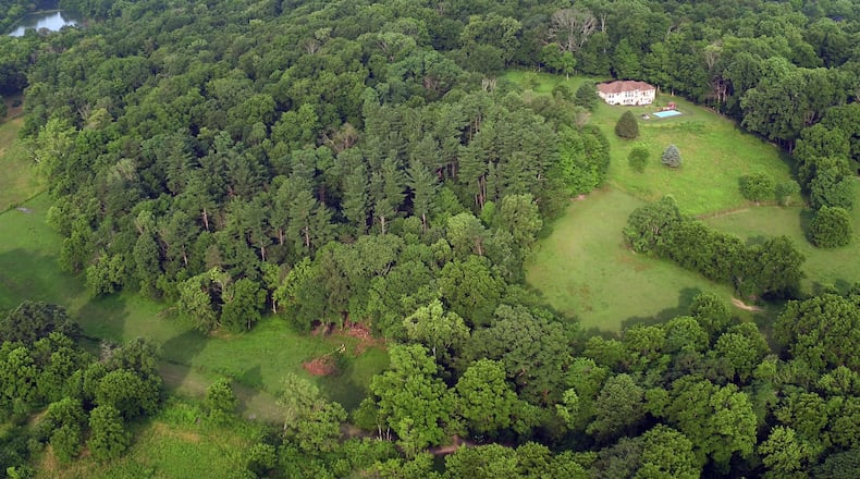 The Kircher family is looking to create Bellbrook Mountain snowtubing, skiing, snowboarding and sledding on family land that includes a steep wooded hillside already carved with trails. This aerial view looking west shows the hillside. TY GREENLEES / STAFF