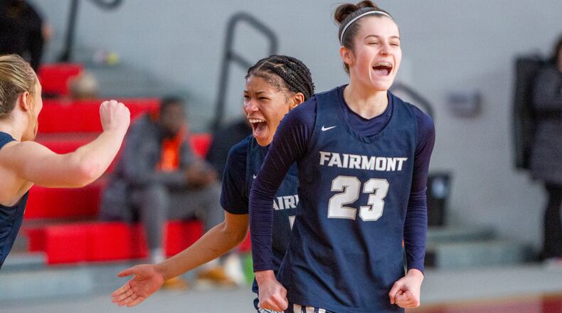 Fairmont's Kenzie Roark (23) and Kaylah Thornton celebrate the Firebirds' 52-40 upset of Bellbrook in Saturday's tournament game at Troy High School. CONTRIBUTED/Jeff Gilbert