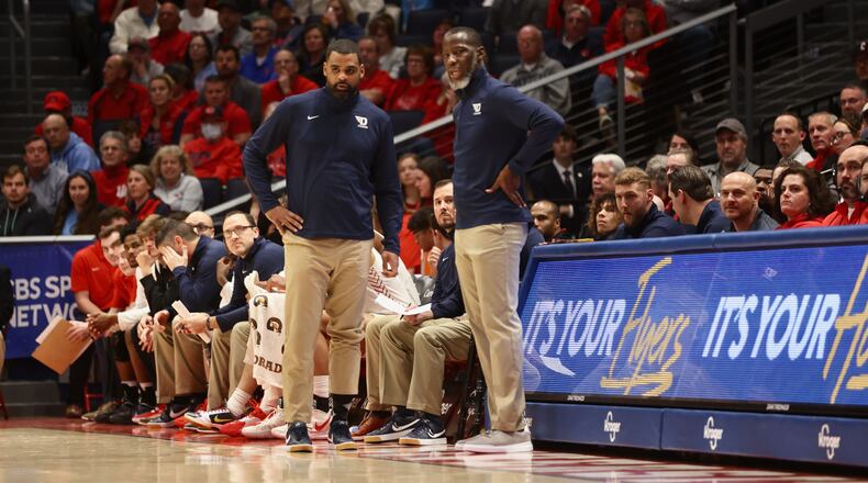 Dayton's Anthony Grant, right, and Ricardo Greer coach during a game against Davidson on Tuesday, Jan. 17, 2023, at UD Arena. David Jablonski/Staff