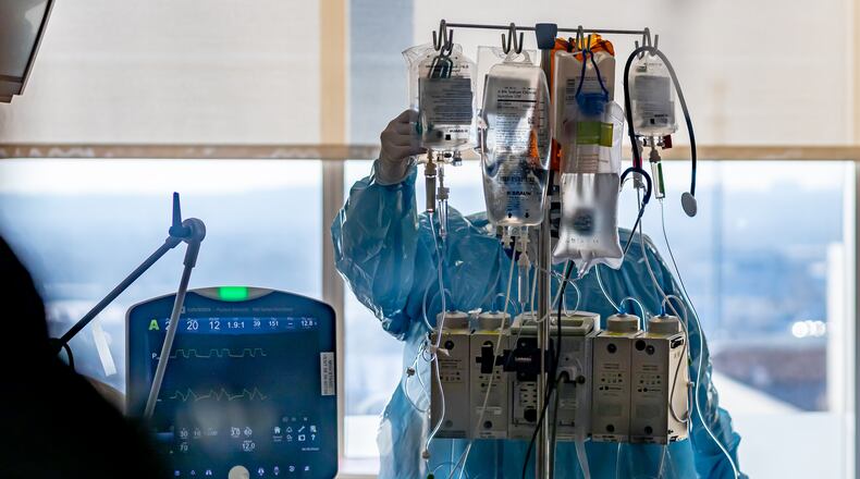Miami Valley Hospital medical staff working in full PPE gear in a COVID-19 patient room in 2020.  CONTRIBUTED BY PREMIER HEALTH