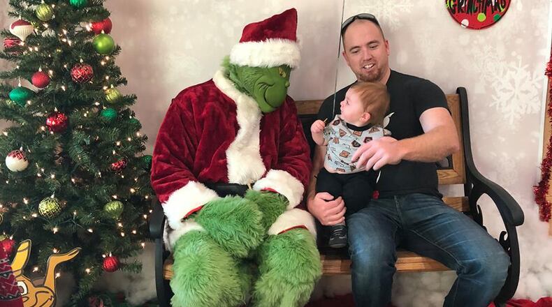 The Grinch meeting a family at Buckeye Harley-Davidson's holiday event.
