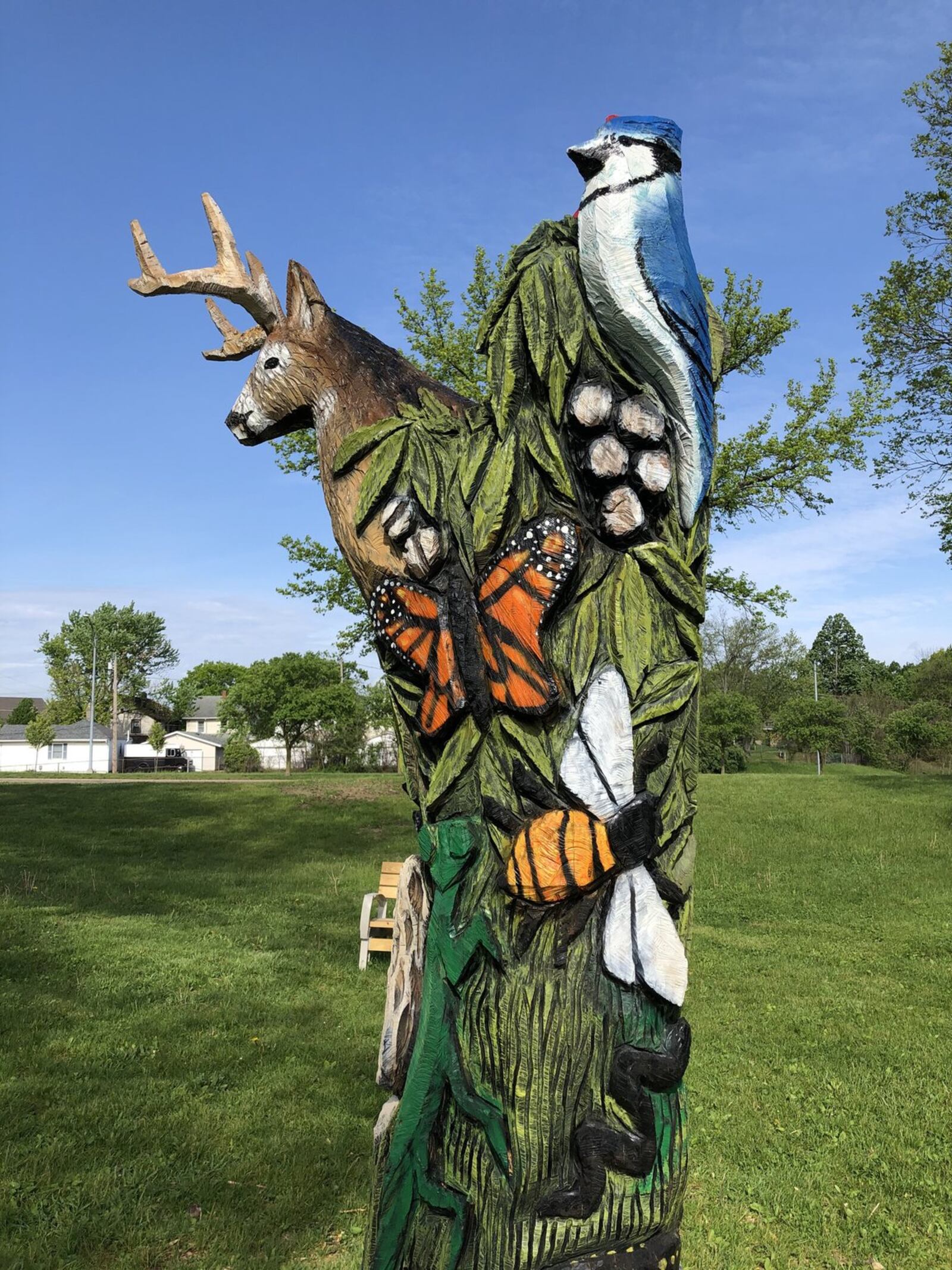A trilobite, a white tail deer, a butterfly and a carnation are among the carvings on the Ohio natural history sculpture at Highland Park in Dayton created by Patrick Allred of Economy, Ind. CONTRIBUTED