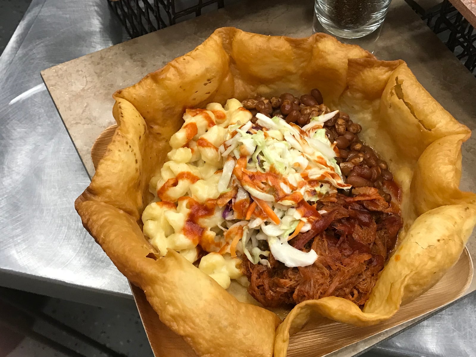 Smokehouse Bowl at Great American Ball Park: Imagine a large, bowl-shaped tortilla shell packed with pulled pork, coleslaw, and mac and cheese, topped with Montgomery Inn BBQ sauce. CONTRIBUTED