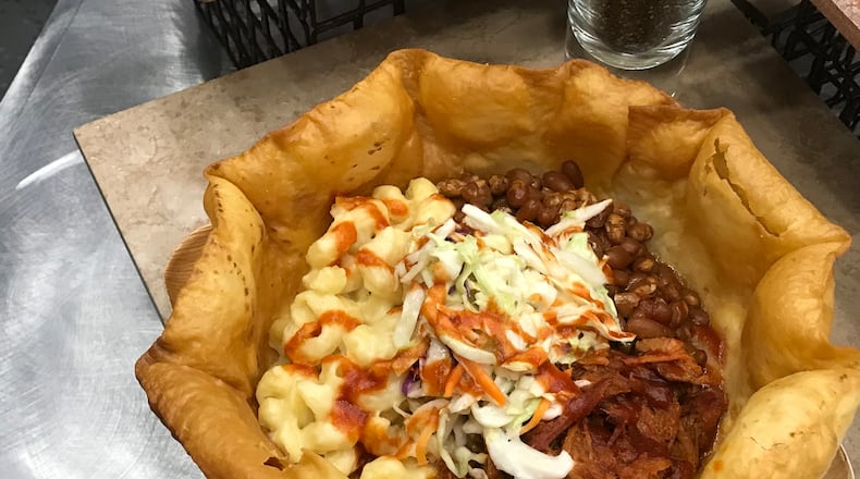 Smokehouse Bowl at Great American Ball Park: Imagine a large, bowl-shaped tortilla shell packed with pulled pork, coleslaw, and mac and cheese, topped with Montgomery Inn BBQ sauce. CONTRIBUTED