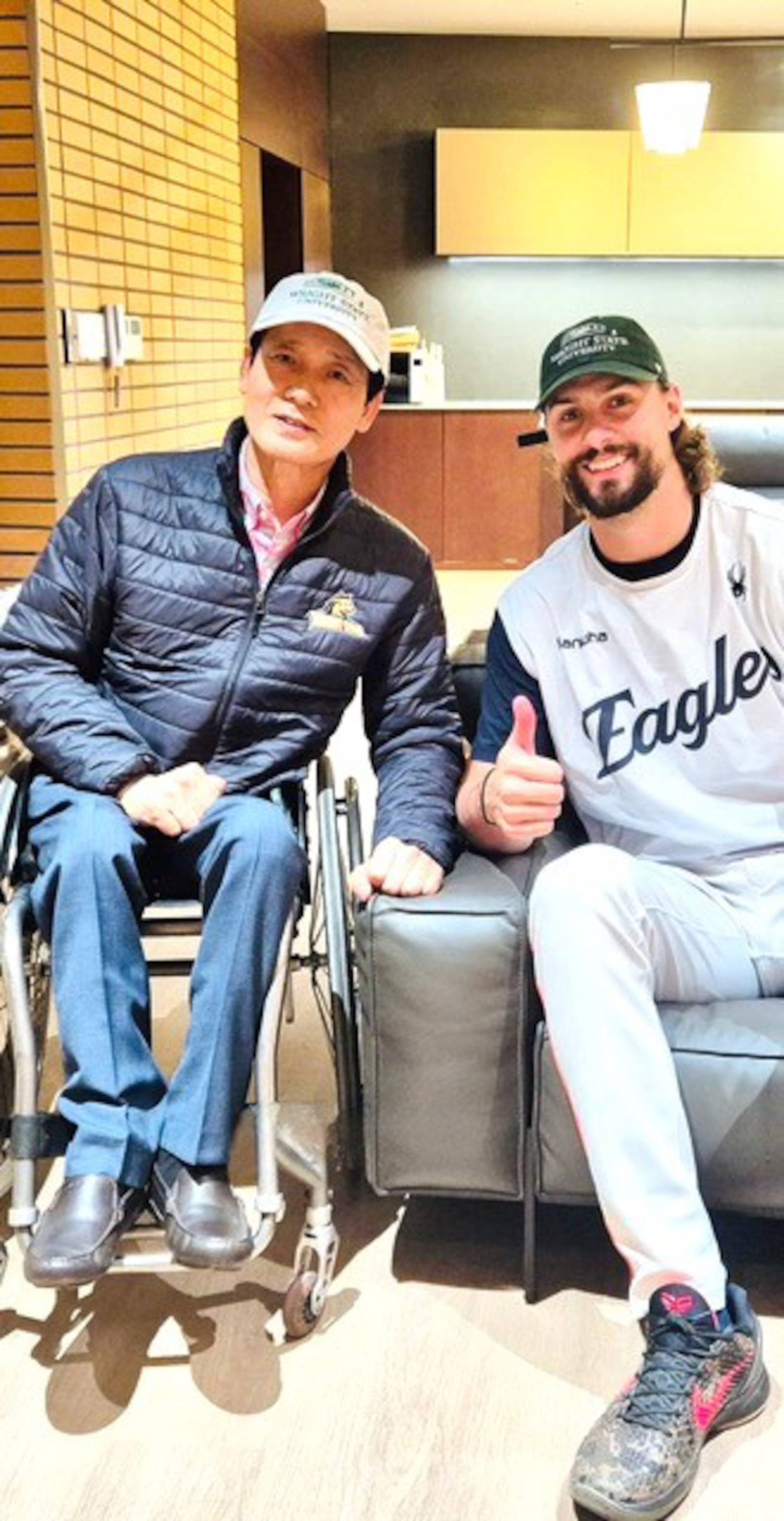 Before a game this past season in Korea, Hanwha Eagles pitcher Ryan Weiss was joined by In-Hong Cha, the director of orchestras and professor of applied violin at Wright State. Cha grew up Daejeon, the home of the Eagles. For this meeting both men wore their WSU caps. CONTRIBUTED PHOTO