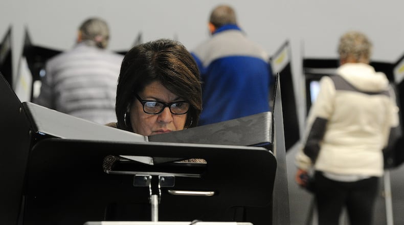 Annette LaCivita reads the ballot while doing in-person early voting Friday, Nov. 3, 2023 at the Greene County Board of Elections in Xenia. MARSHALL GORBY\STAFF