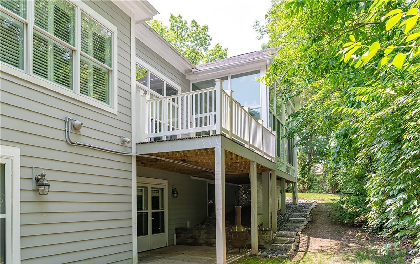 The backyard is mostly wooded and the home has a walk out basement, a main level three seasons room and a deck. CONTRIBUTED