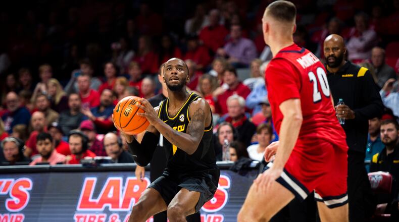 Missouri guard Amari Davis (1) is defended by Liberty's Keegan McDowell during an NCAA college basketball game Thursday, Dec. 2, 2021, in Lynchburg, Va. (Kendall Warner/The News & Advance via AP)