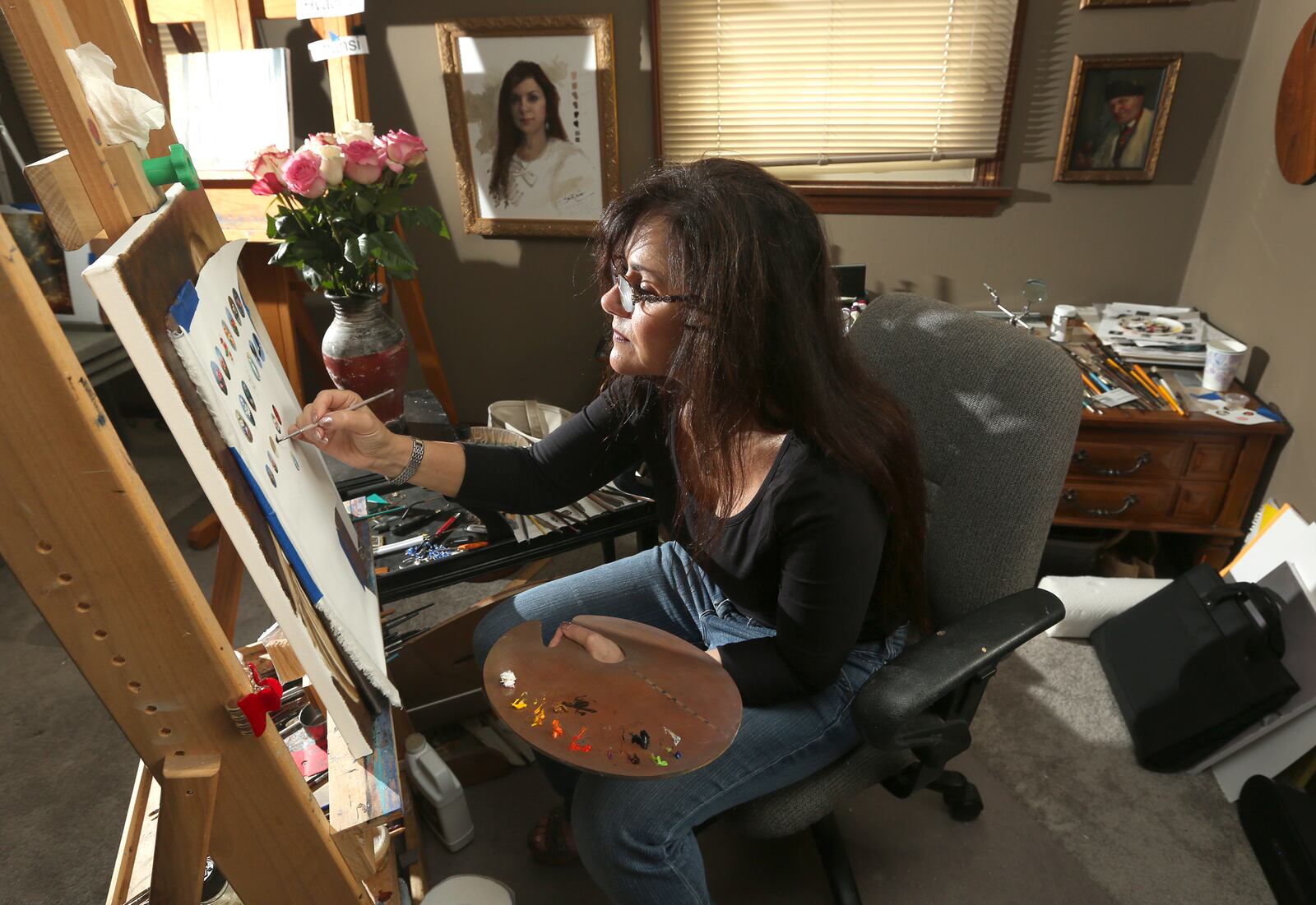 Cecilia Brendel, a professional painter for two decades and the owner of Olde World Masters Galleria in Centerville, has created a unique jewelry collection of miniature oil paintings. LISA POWELL / STAFF