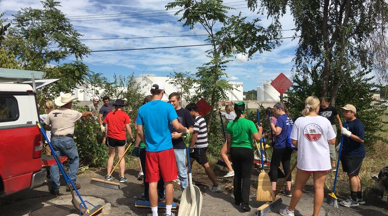 More than 100 University of Dayton student volunteers and 150 total volunteers worked Saturday in Old North Dayton near Valley Street to continue cleanup efforts following the Memorial Day tornadoes. STAFF PHOTO / SARAH FRANKS