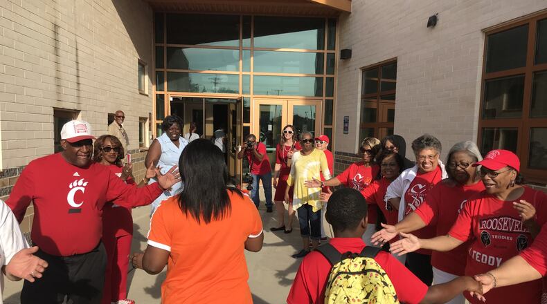 Dayton Public Schools employees and school board members join community leaders and graduates of the former Roosevelt High School in welcoming students to the first day of classes Monday at Roosevelt Elementary on West Third Street. The school, which was called Dayton Boys Prep in recent years, was renamed Roosevelt because Boys Prep was combined with the World of Wonder school that closed in May 2019. CHUCK HAMLIN / STAFF