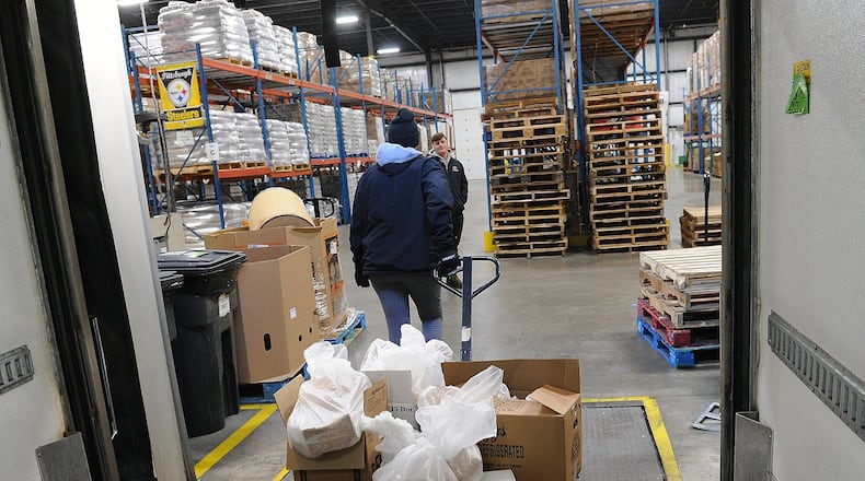 Foodbank Inc. workers pull pallets of food into the food bank's warehouse on Nov. 2, 2023. MARSHALL GORBY\STAFF