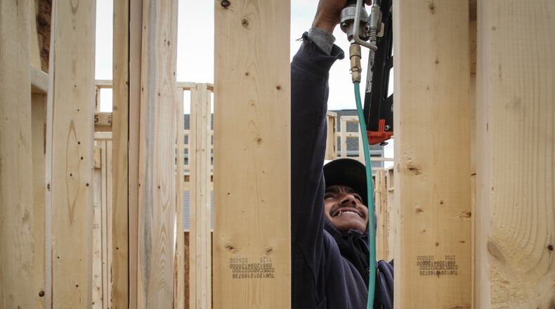 Framer, Eddie Arreola nails up a wall on a house on Gulf Stream Place in Huber Heights.