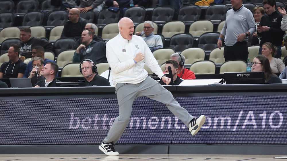 St. Bonaventure's Mark Schmidt celebrates a victory against George Mason in the second round of the Atlantic 10 Conference tournament on Thursday, March 12, 2026, at PPG Paints Arena in Pittsburgh. David Jablonski/Staff